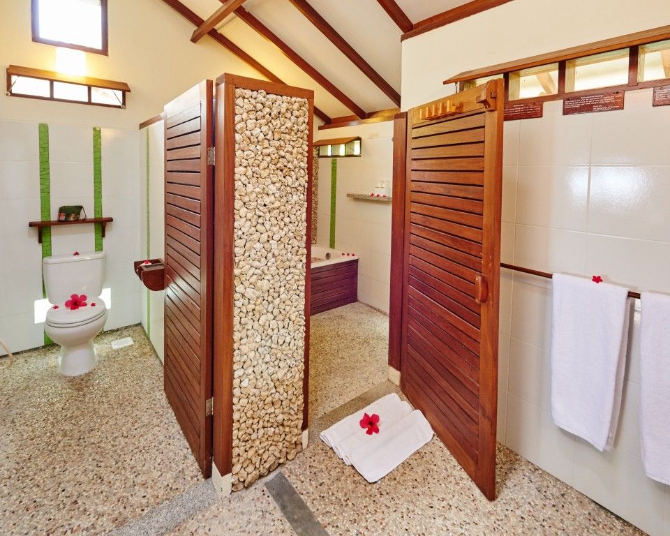 A bathroom with a toilet , shower and bathtub