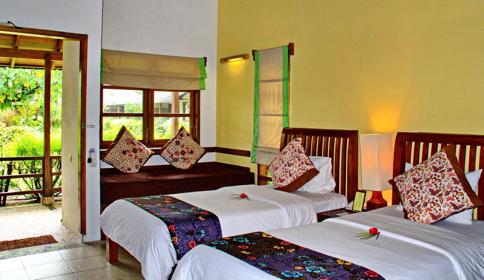 A hotel room with two beds and a couch