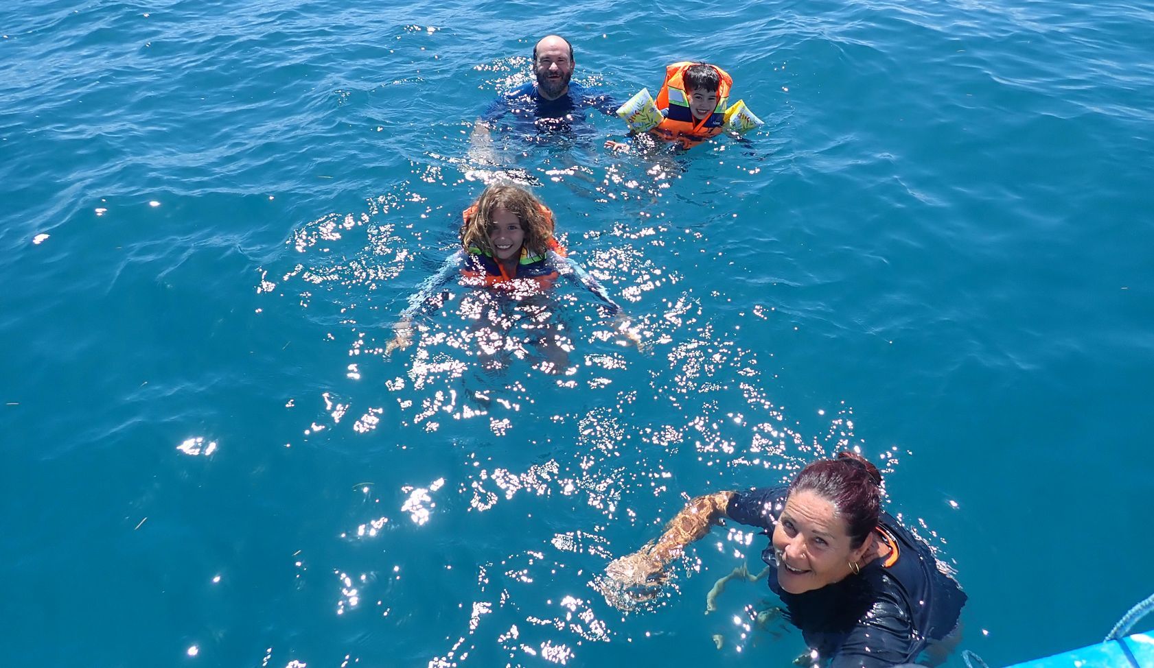 A group of people are swimming in the ocean.