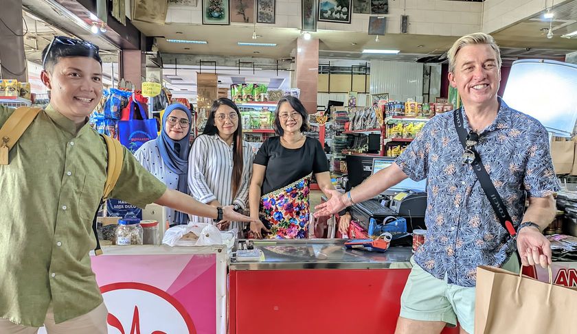 A group of people are standing in a store holding hands.