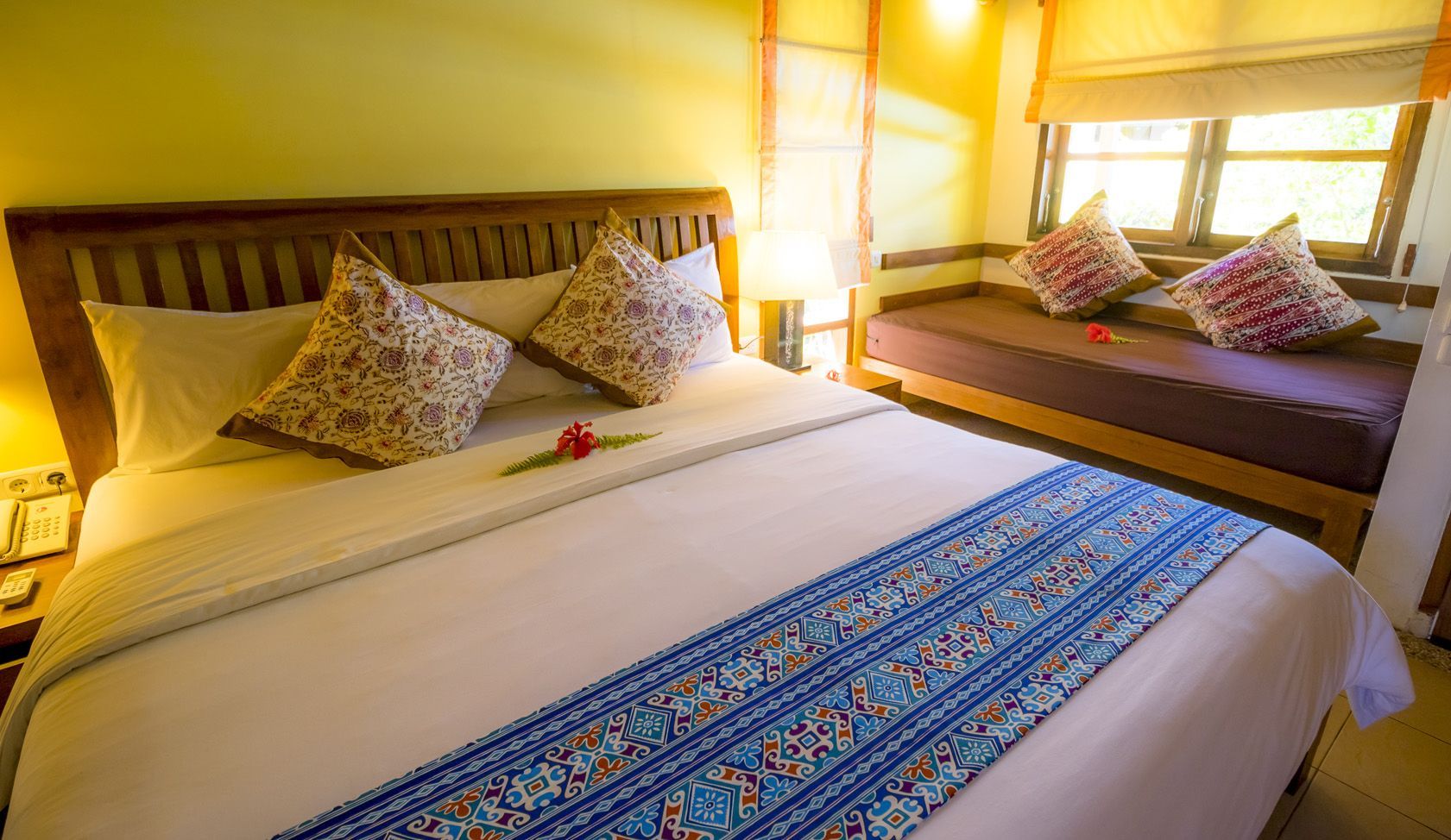 A hotel room with a king size bed and a couch.