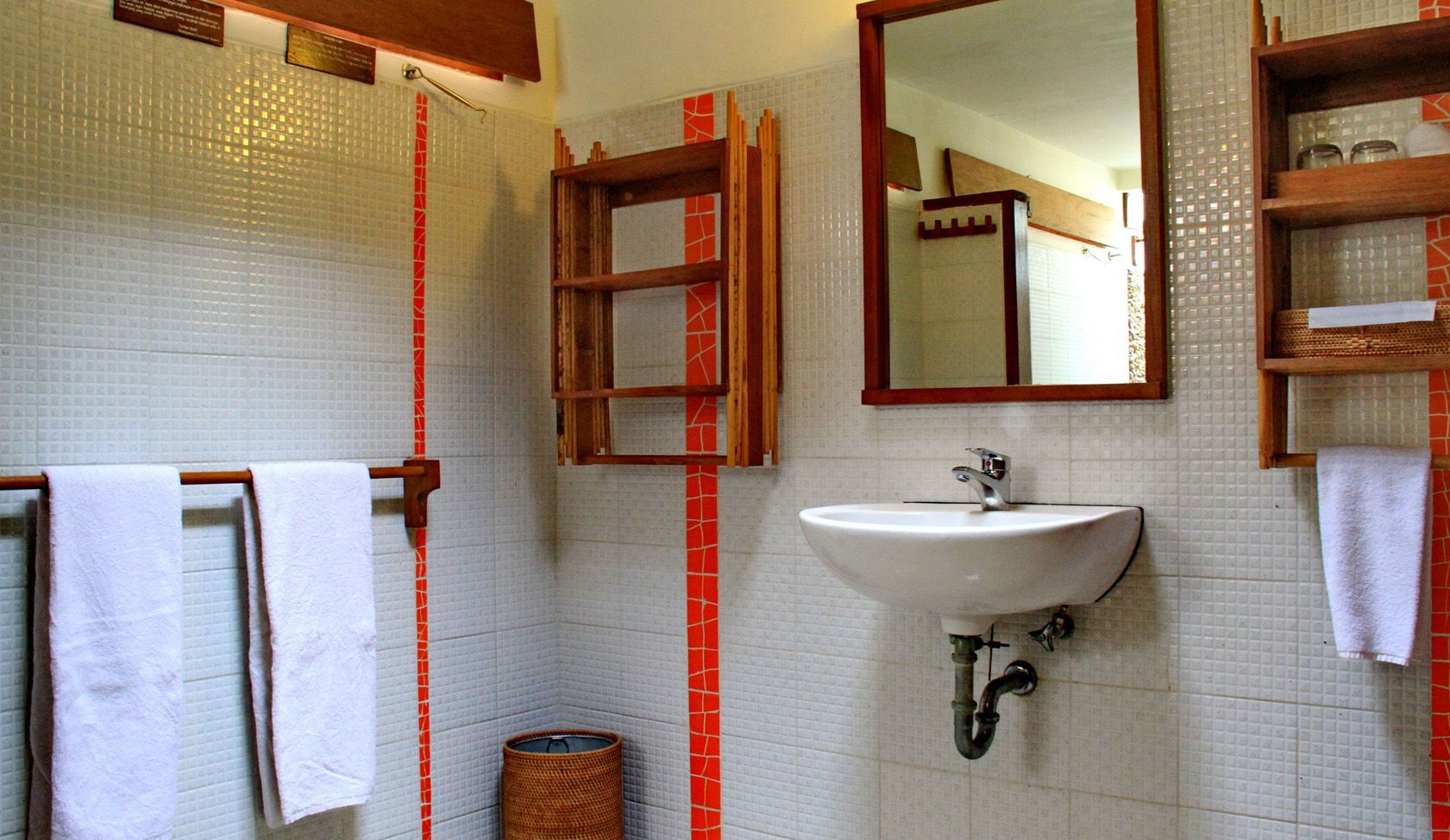 A bathroom with a sink , mirror and towels