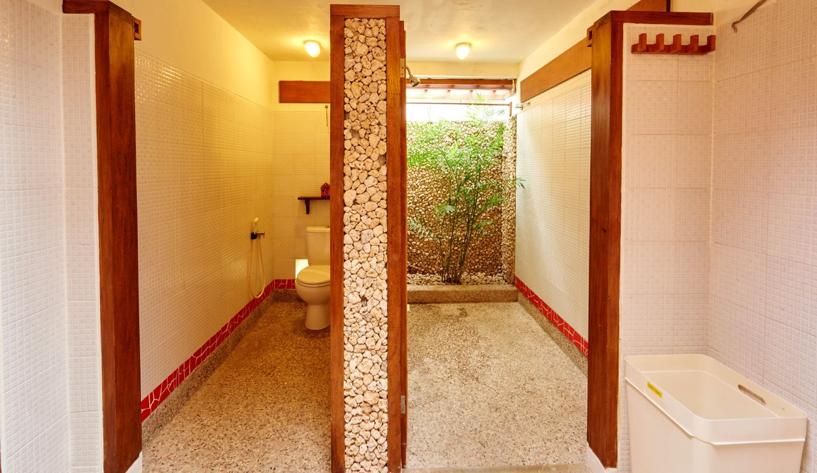 A bathroom with a toilet , sink and shower.
