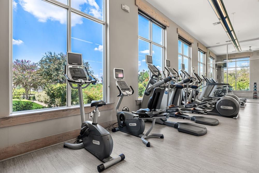 a gym filled with lots of exercise bikes and ellipticals at Marquis at Canyon Ridge in Austin, TX