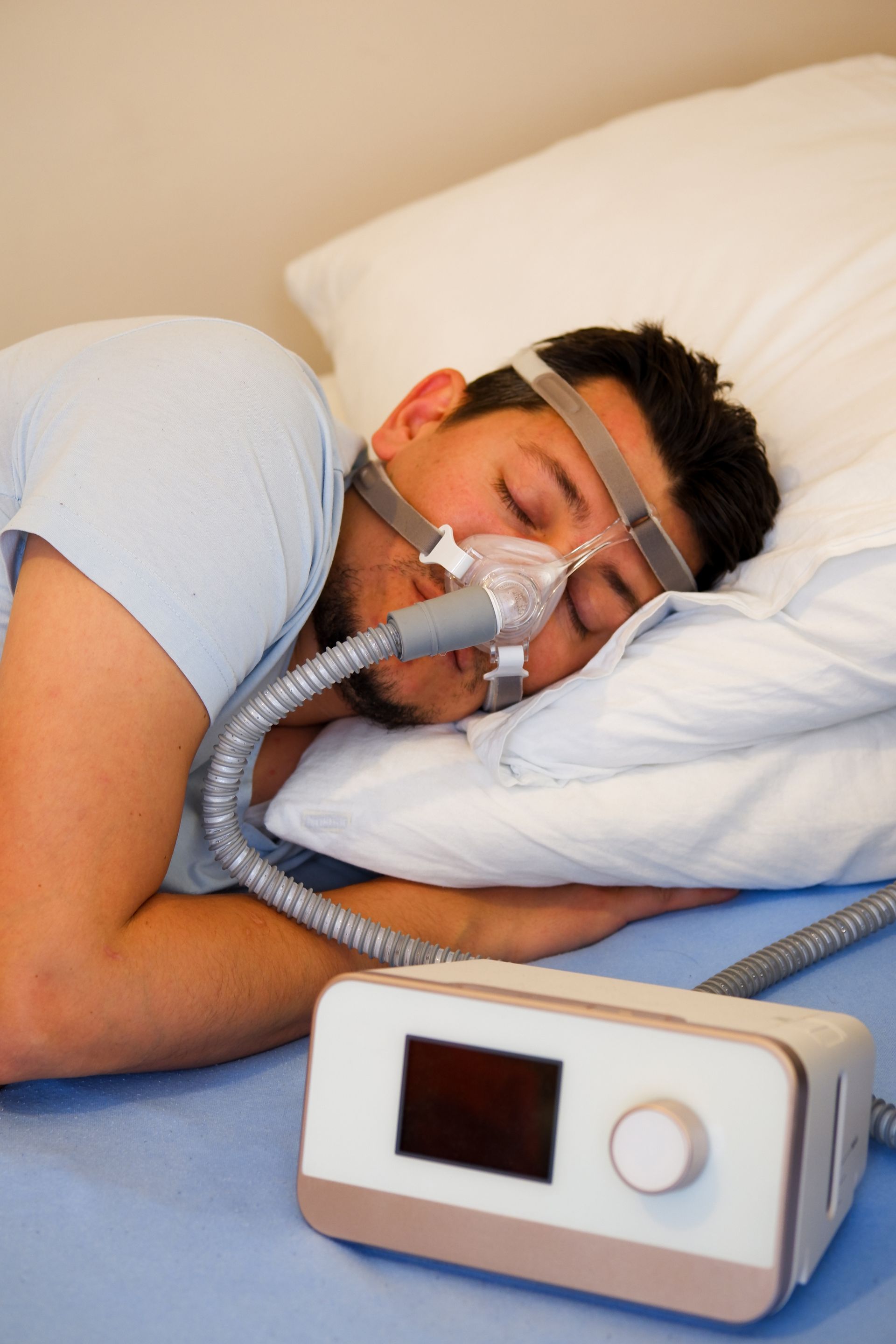A man is sleeping with an oxygen mask on his face