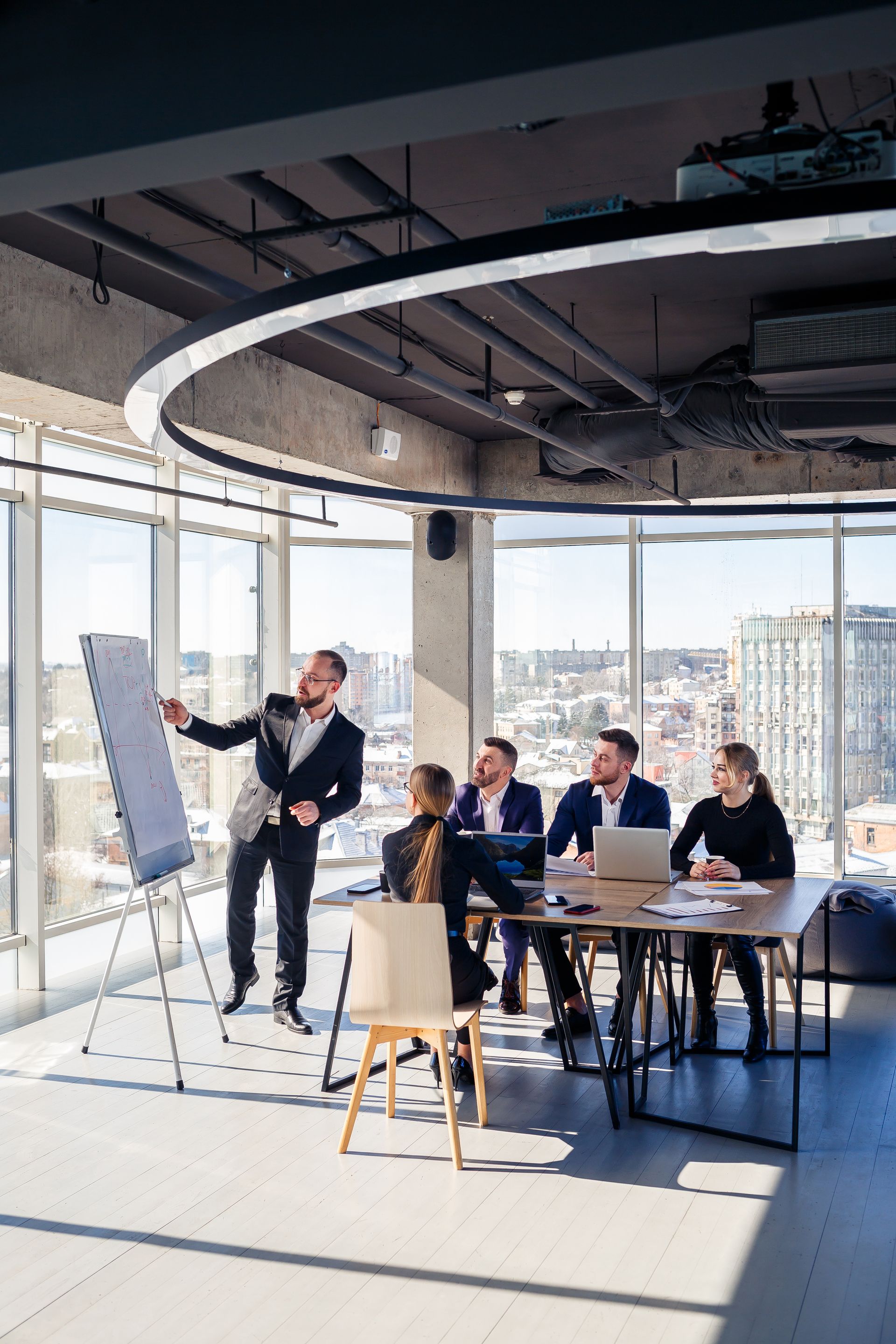 A man is giving a presentation to a group of people in a conference room.