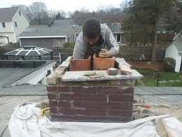 Mason in the process of a Brick Chimney Repair in Worcester, MA