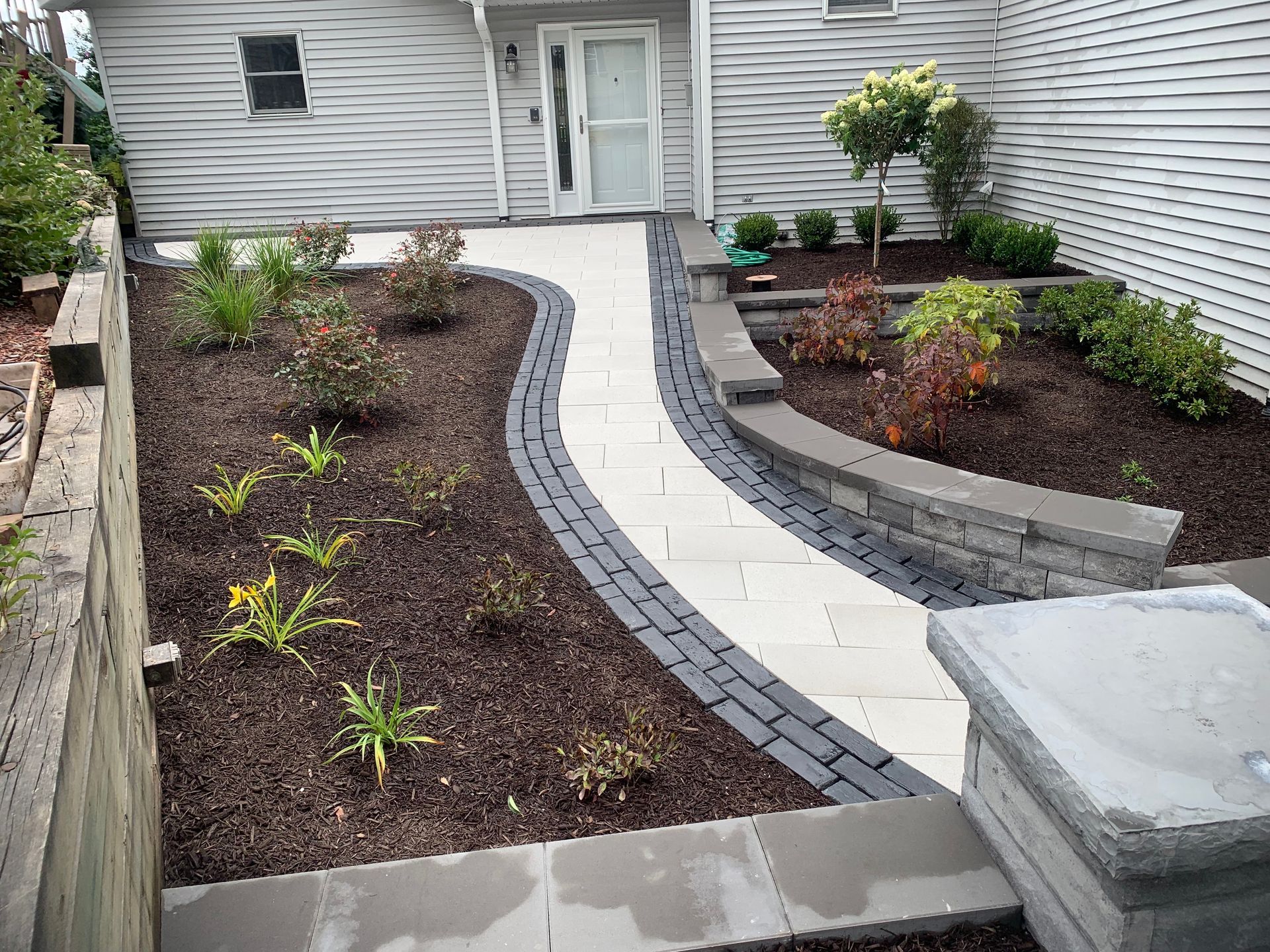 walkway leading to the front door of a house in Valparaiso, IN with retaining wall