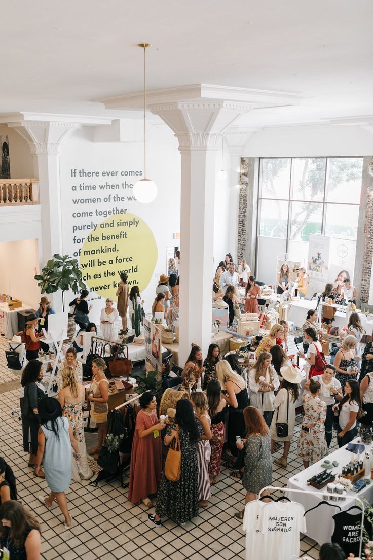 Experiential Events - Large, bright room with crowd of people browsing vendor booths.