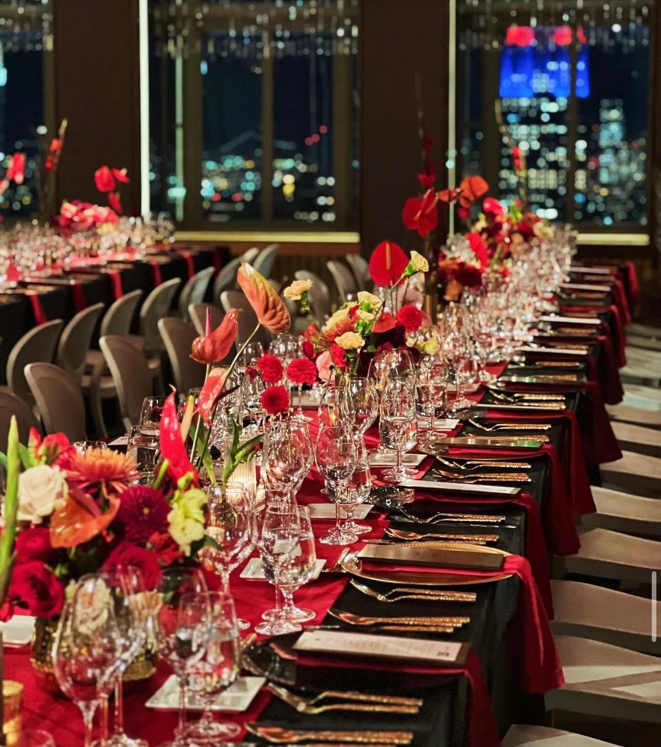 Private Dinners - Elegant table setting with gold utensils, white plates, pink napkin, and a name card.