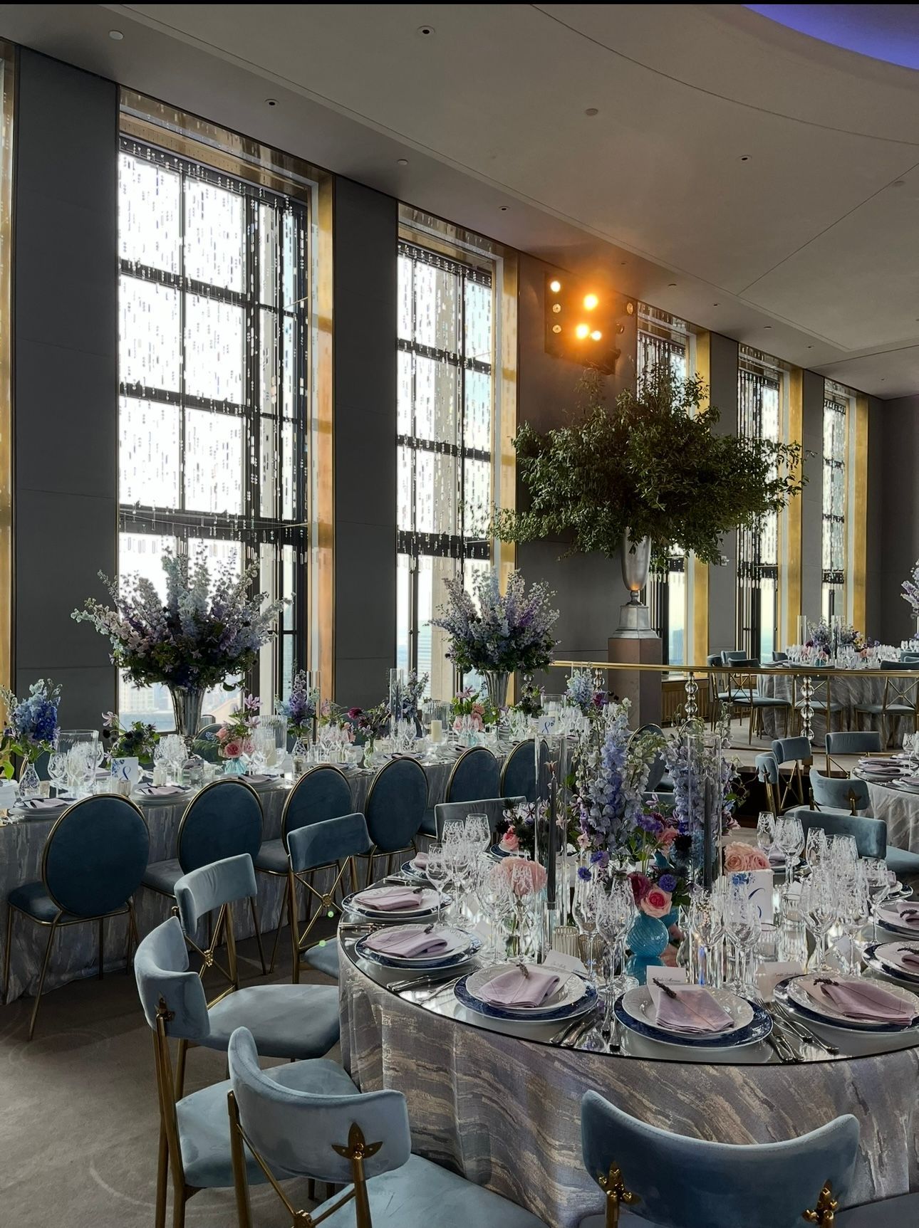Couple embracing; man in tan suit, woman in white dress, soft lighting.