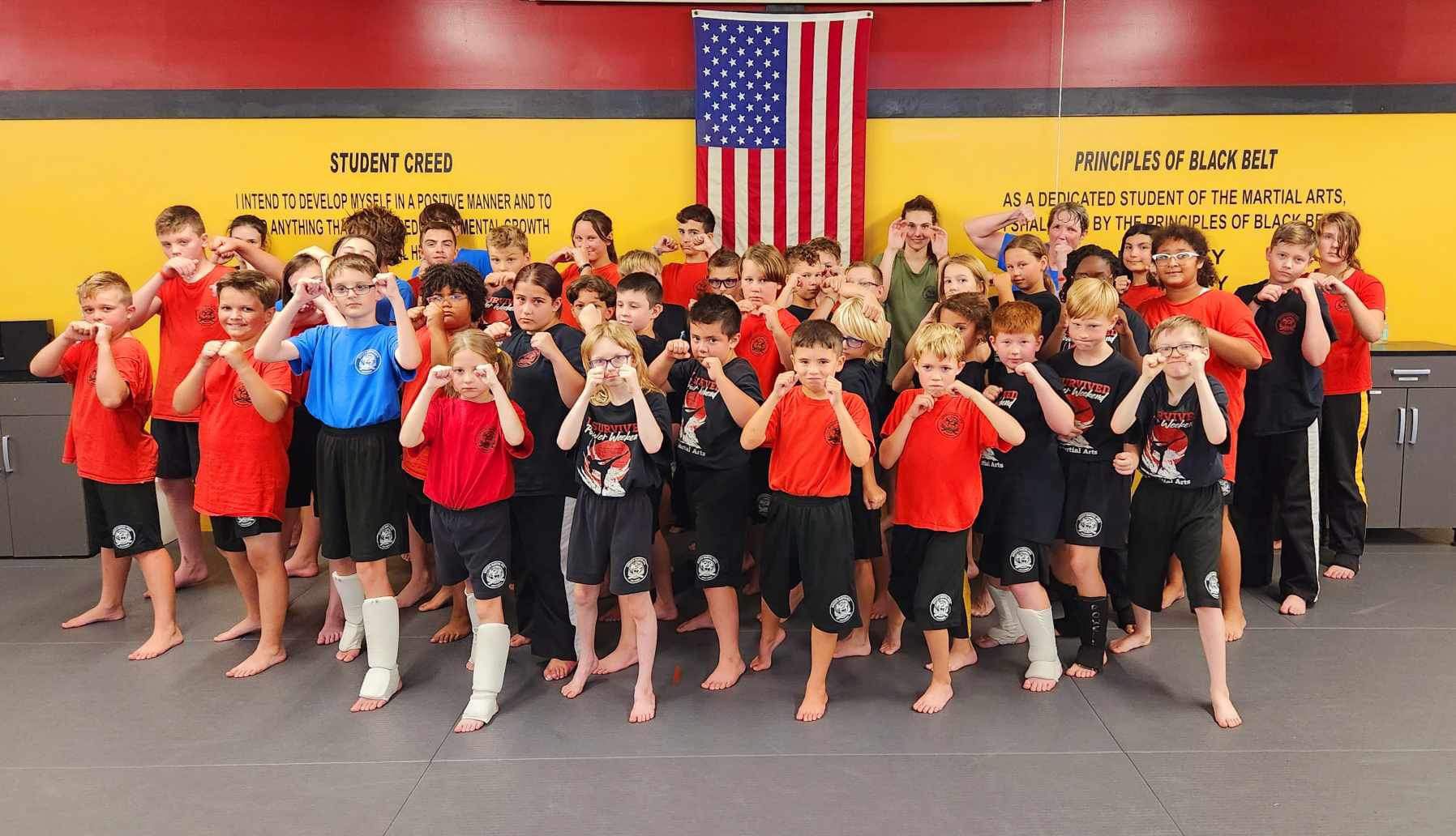 a group of kids are posing for a picture in front of a sign that says student creed