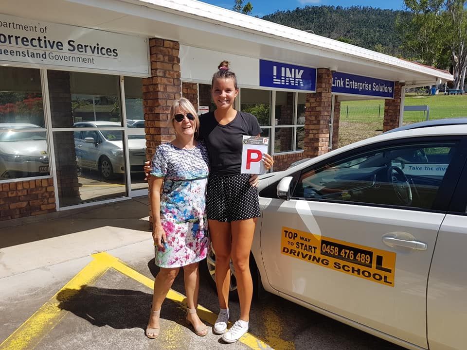Woman and Teen Holding a P Plate Next to a Car — Top Start Driving School (Whitsunday) In Airlie Beach, QLD