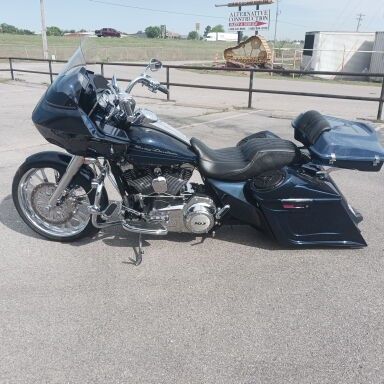 A harley davidson road glide is parked in a parking lot.