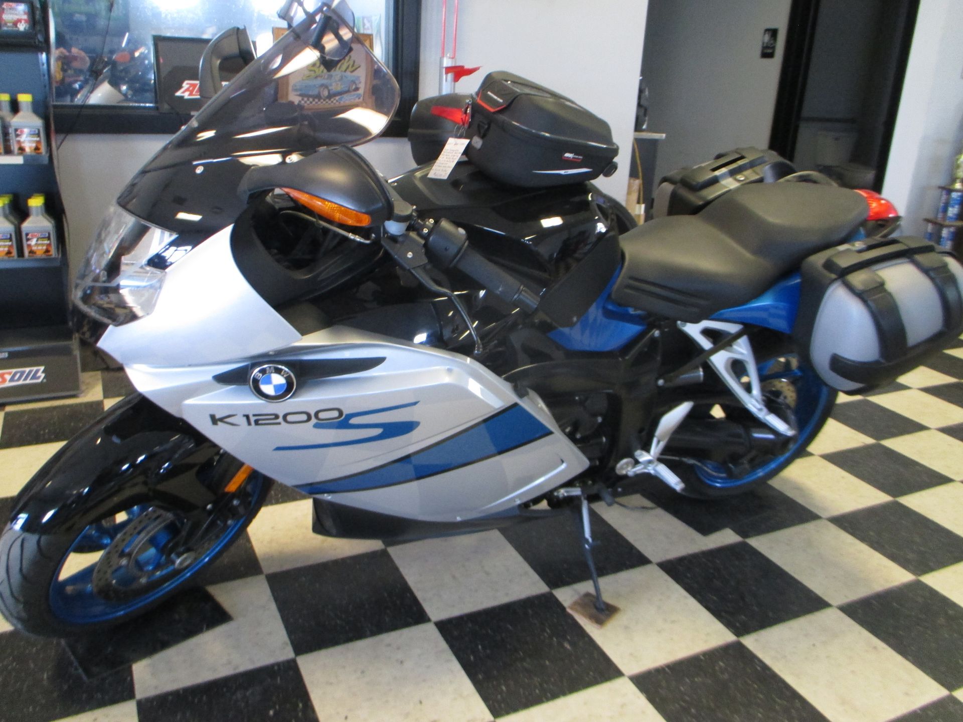 A bmw motorcycle is parked on a checkered floor