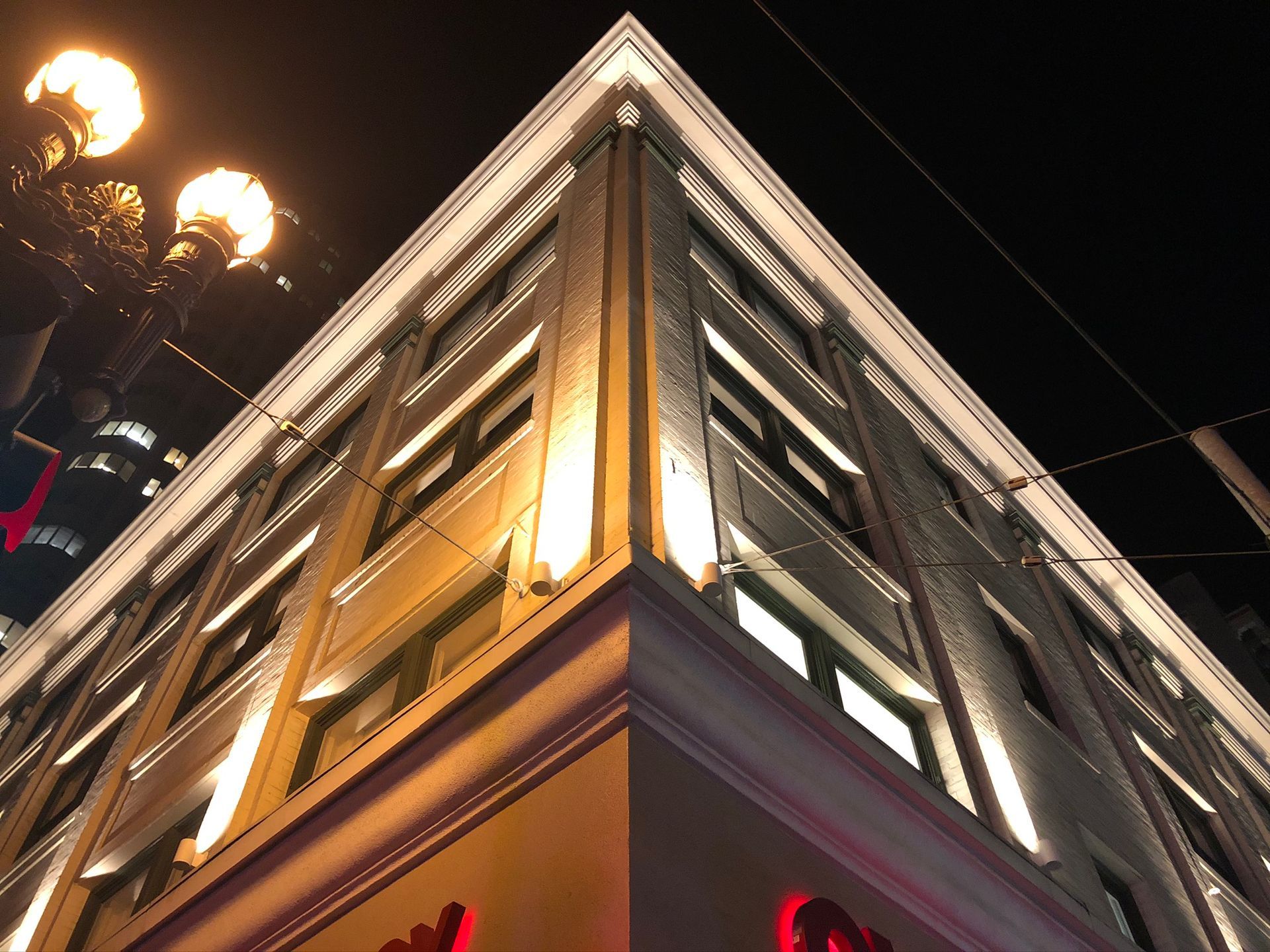 The corner of a building with a red sign that says ' chick-fil-a ' on it