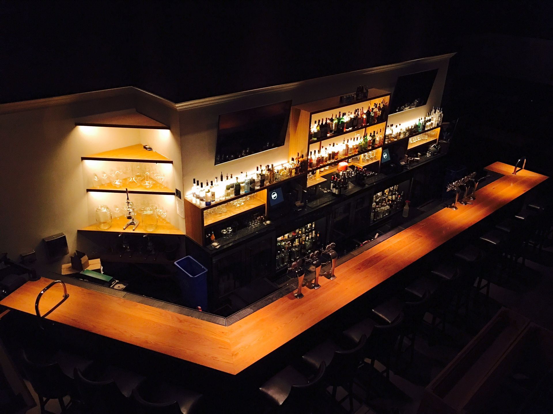 An aerial view of a bar with lots of bottles on shelves