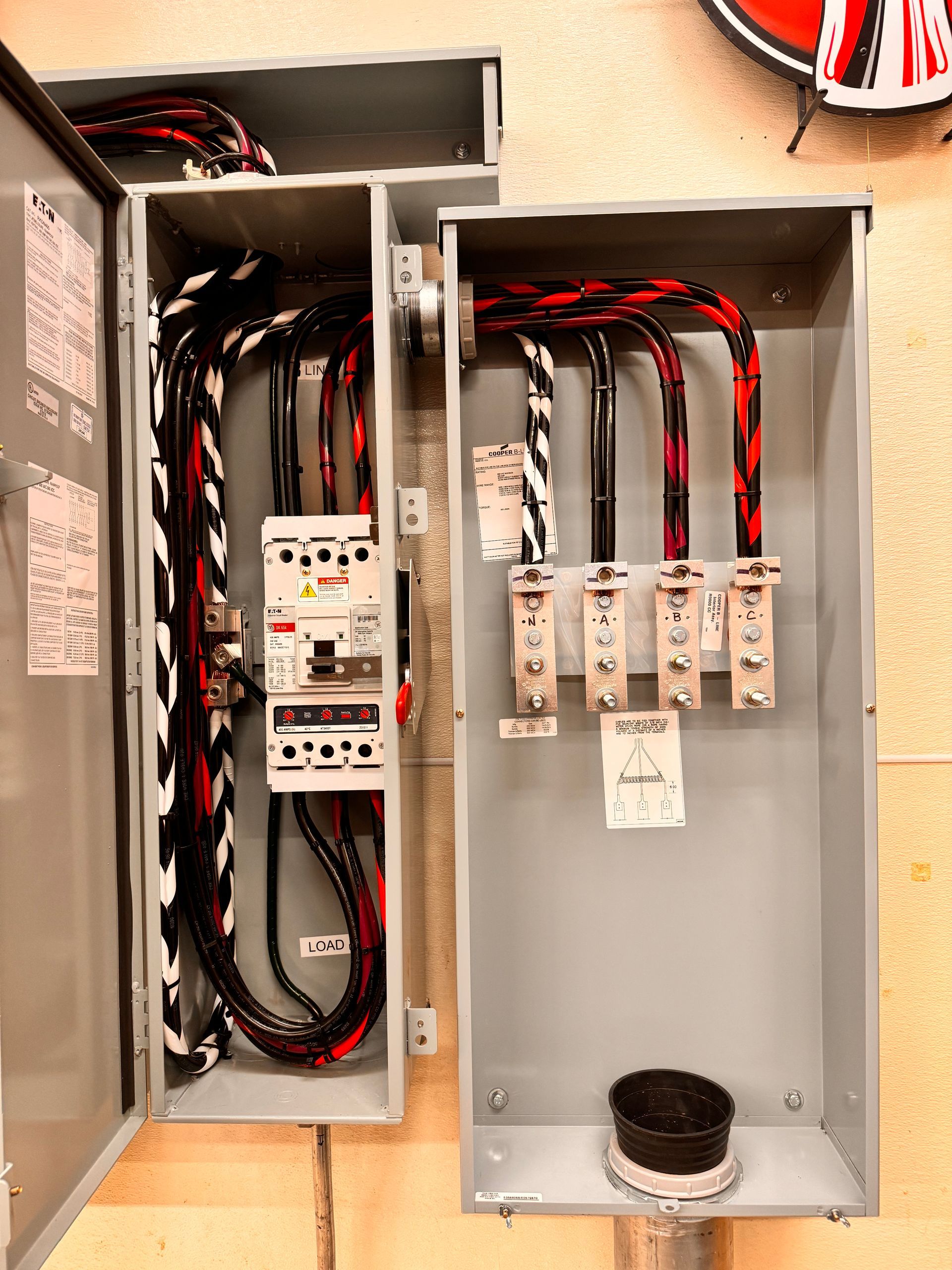 Two electrical boxes are connected to each other on a wall