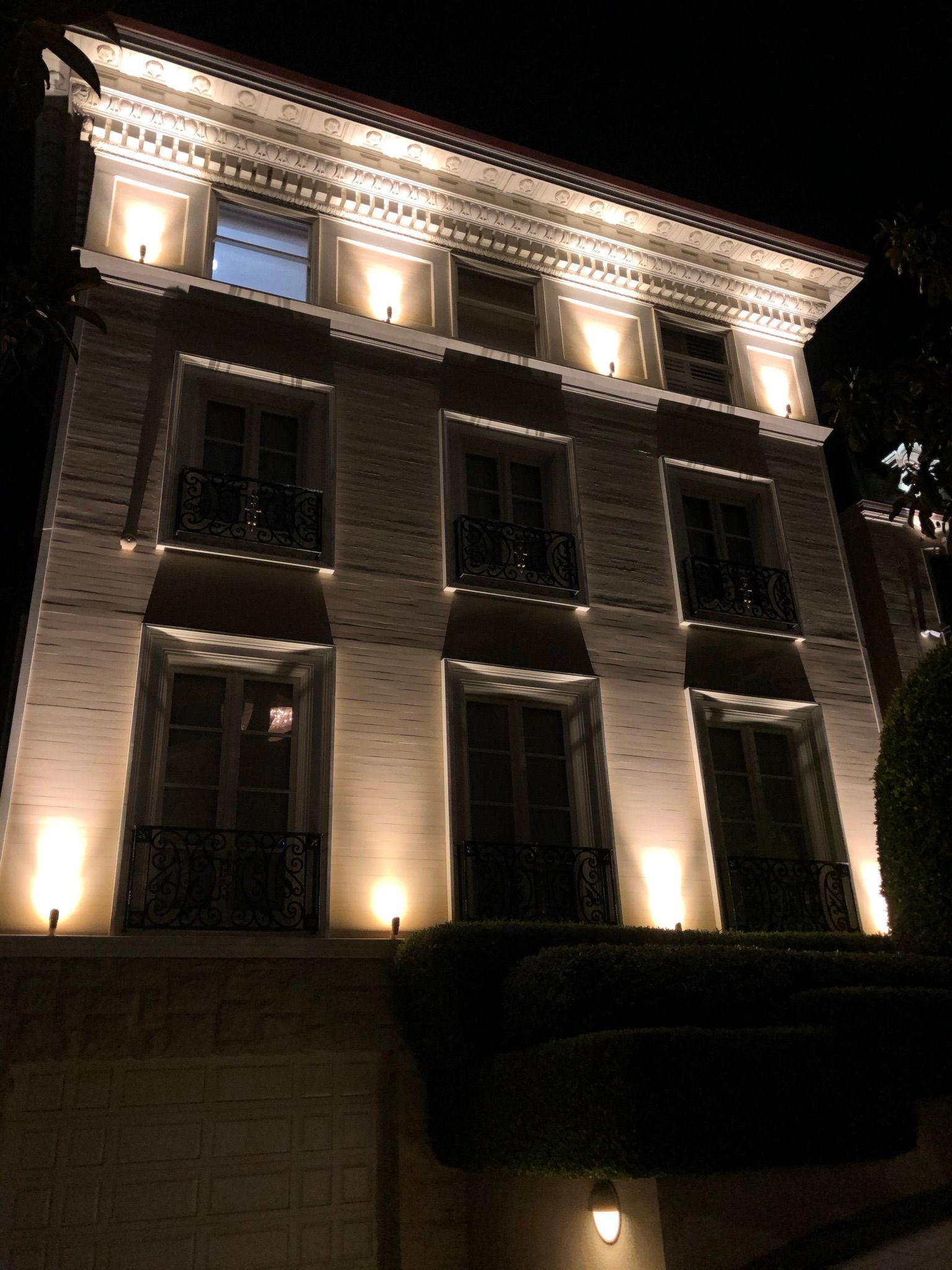 A large building with a lot of windows is lit up at night