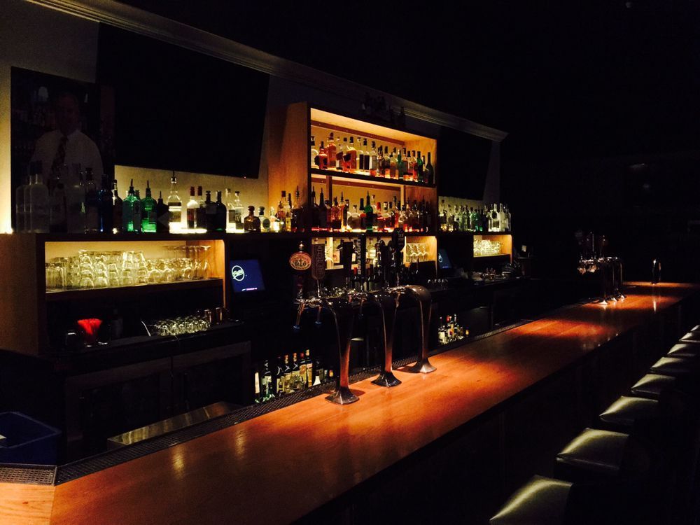 A bar filled with lots of bottles and glasses