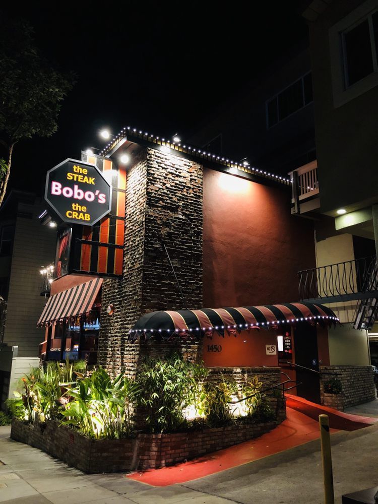 A bob 's steak and crab restaurant is lit up at night