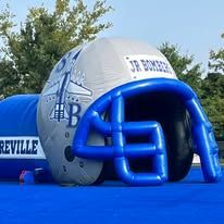 Inflatable football helmet entrance, blue and gray, for a team called Jr. Bombers.