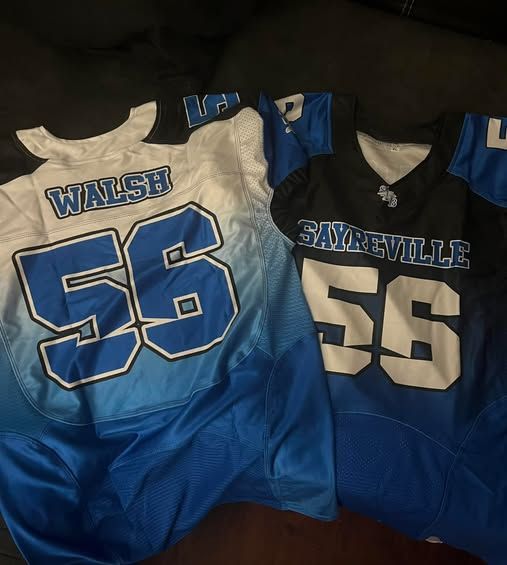 Two football jerseys: one white/blue with 
