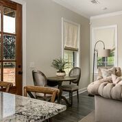 Interior dining area with a round table, two chairs, and a tufted sofa.