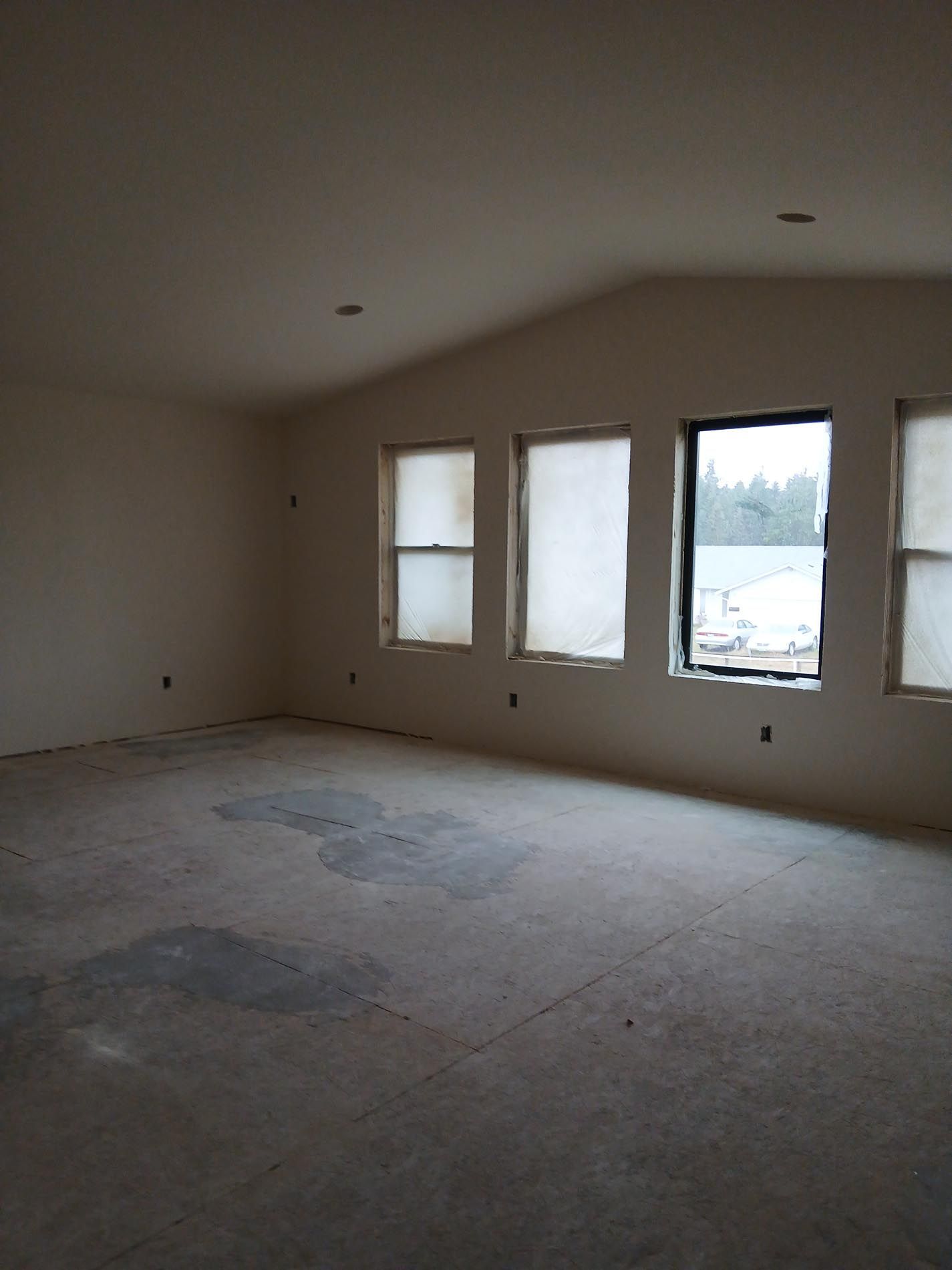 A large empty room with a lot of windows