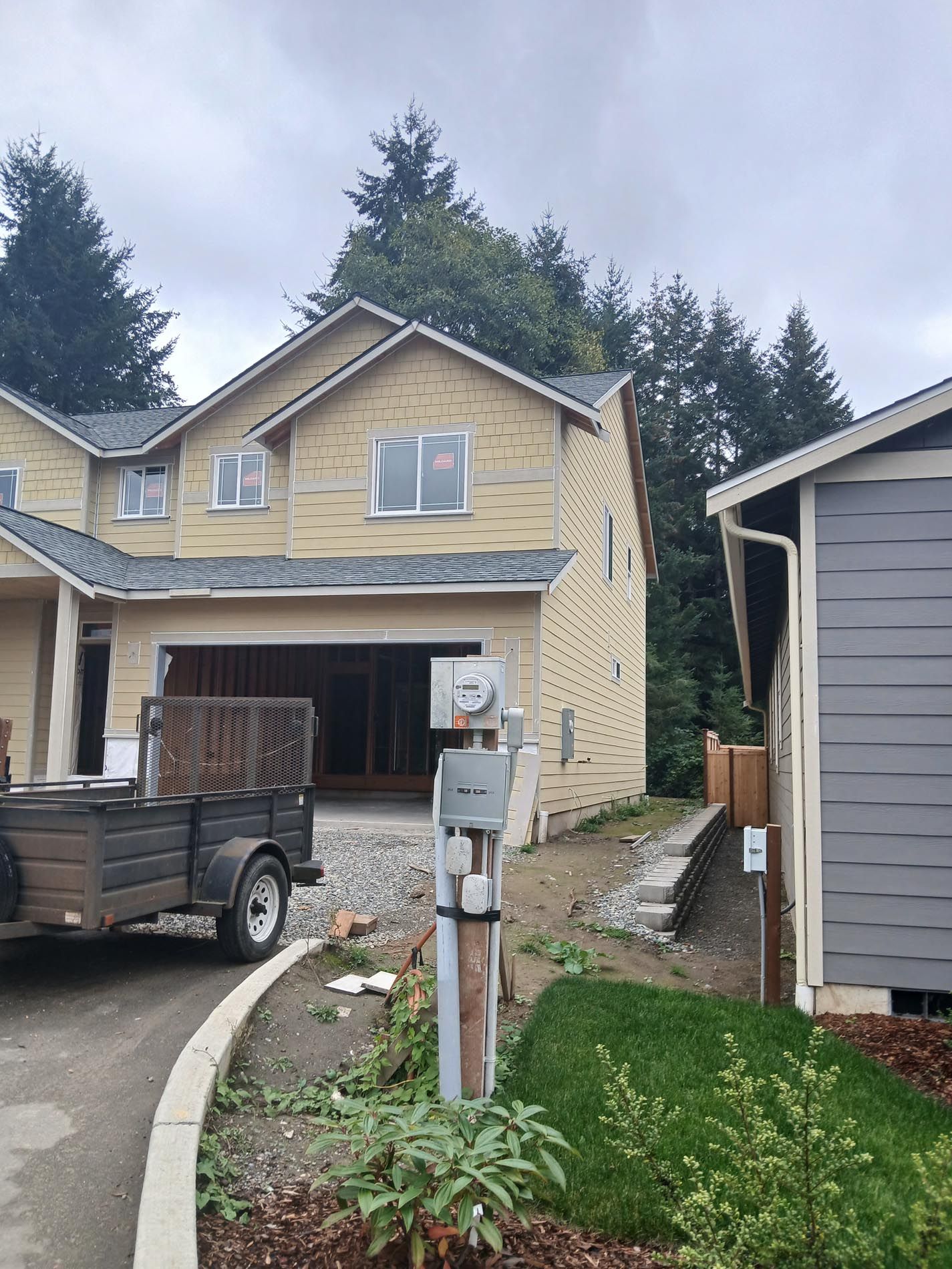 A truck is parked in front of a house under construction.