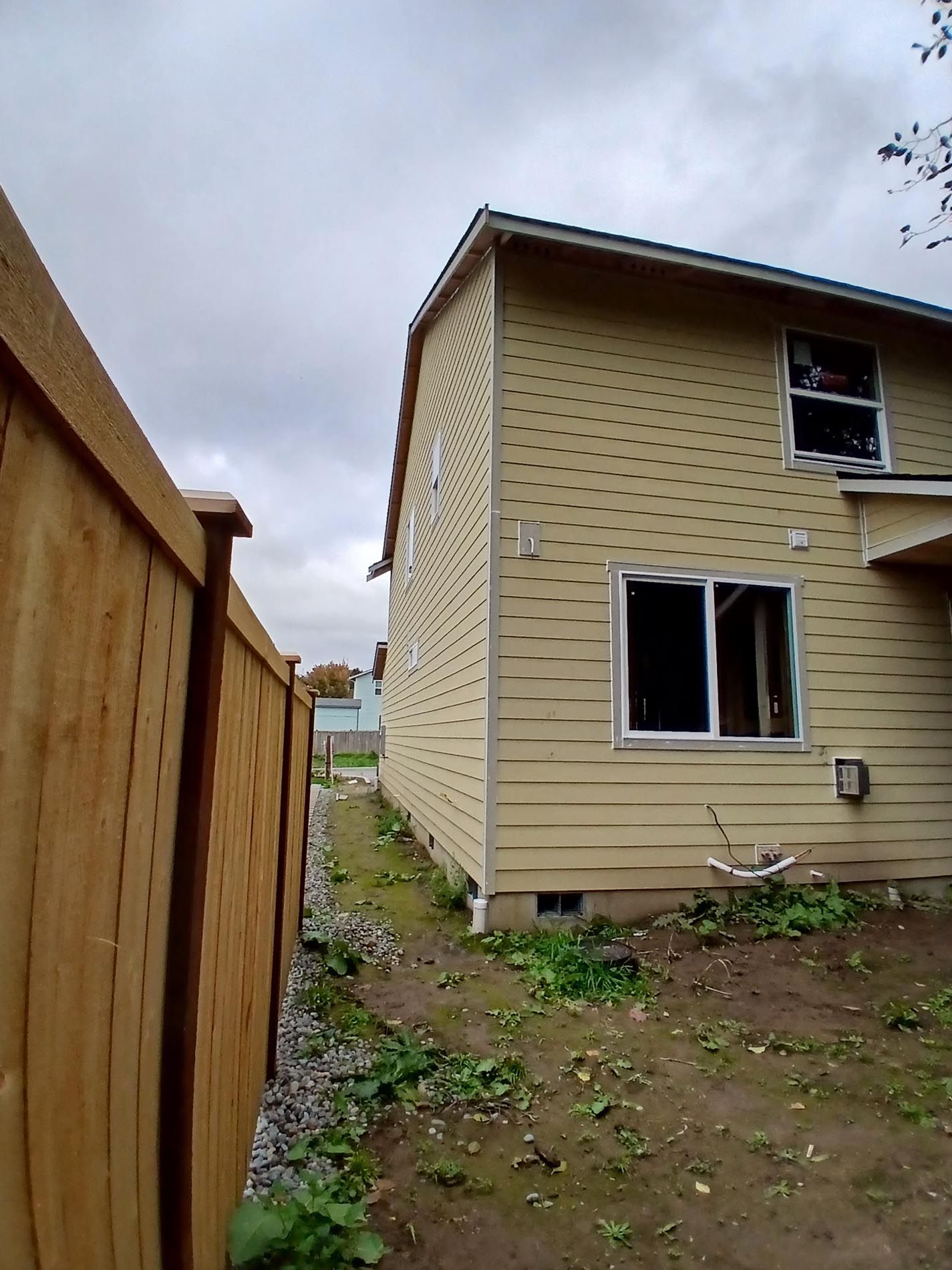 A house with a wooden fence in front of it