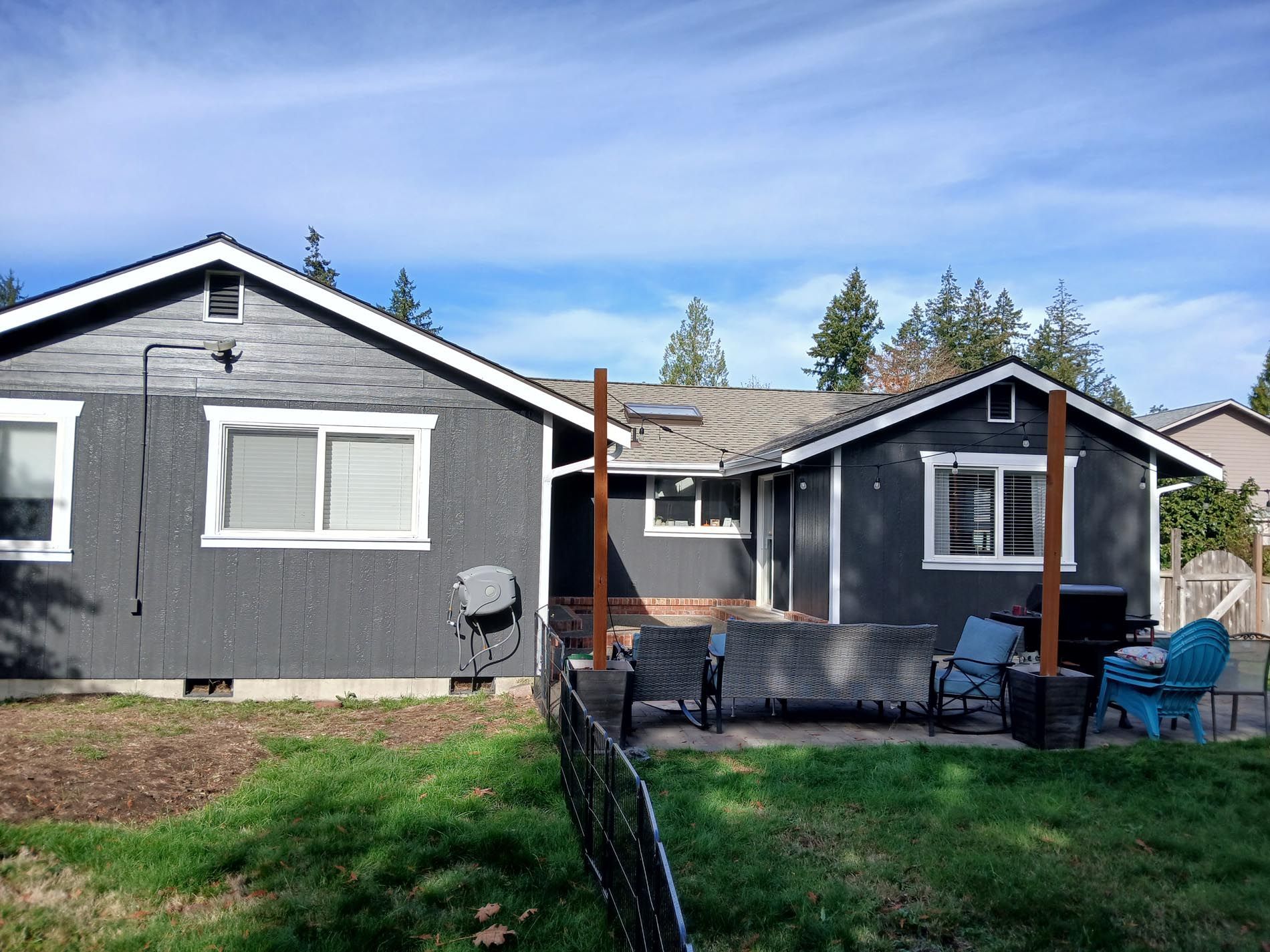 A house with a lot of windows and a fence in front of it.