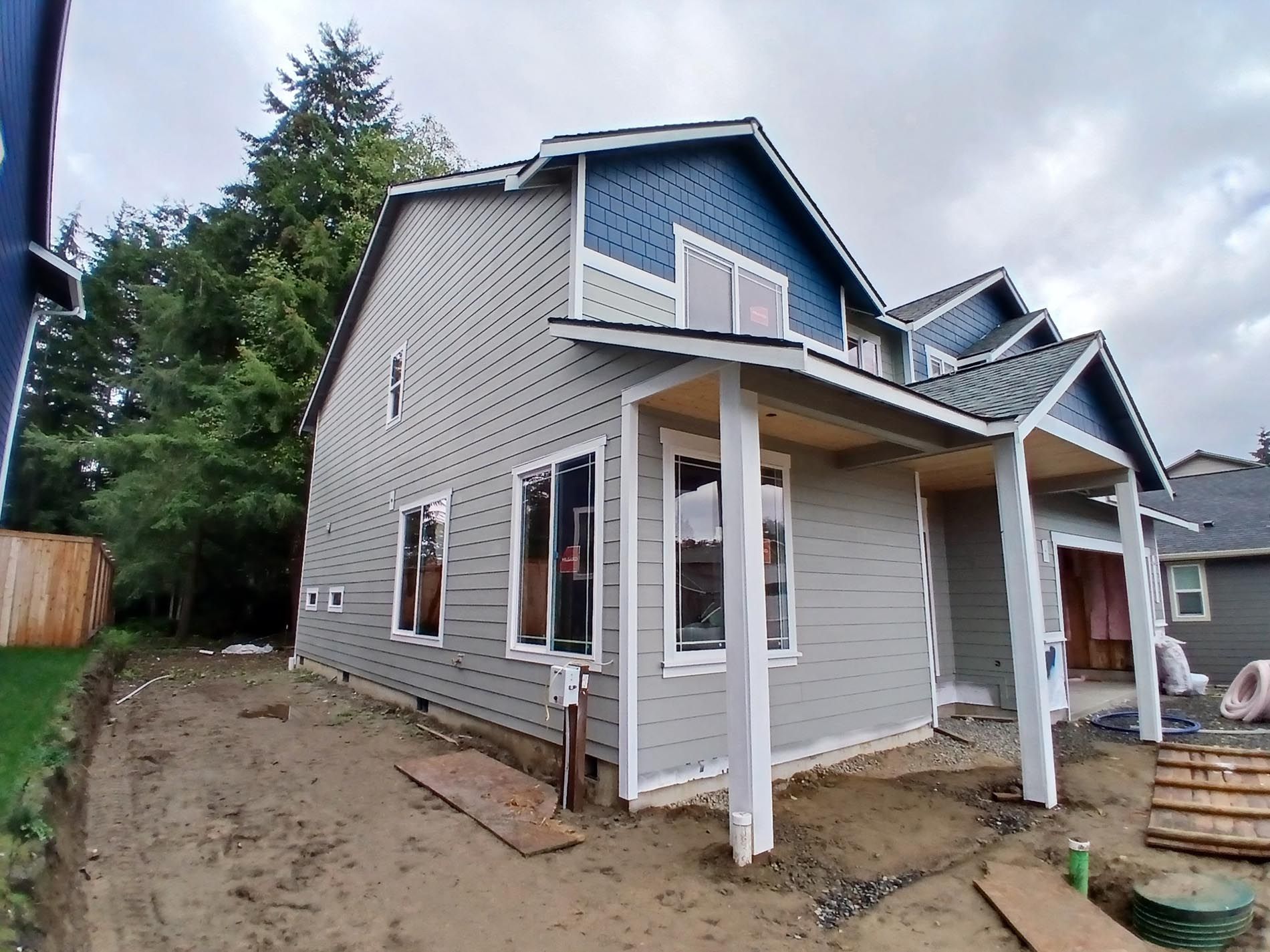 A house that is being built with a lot of windows
