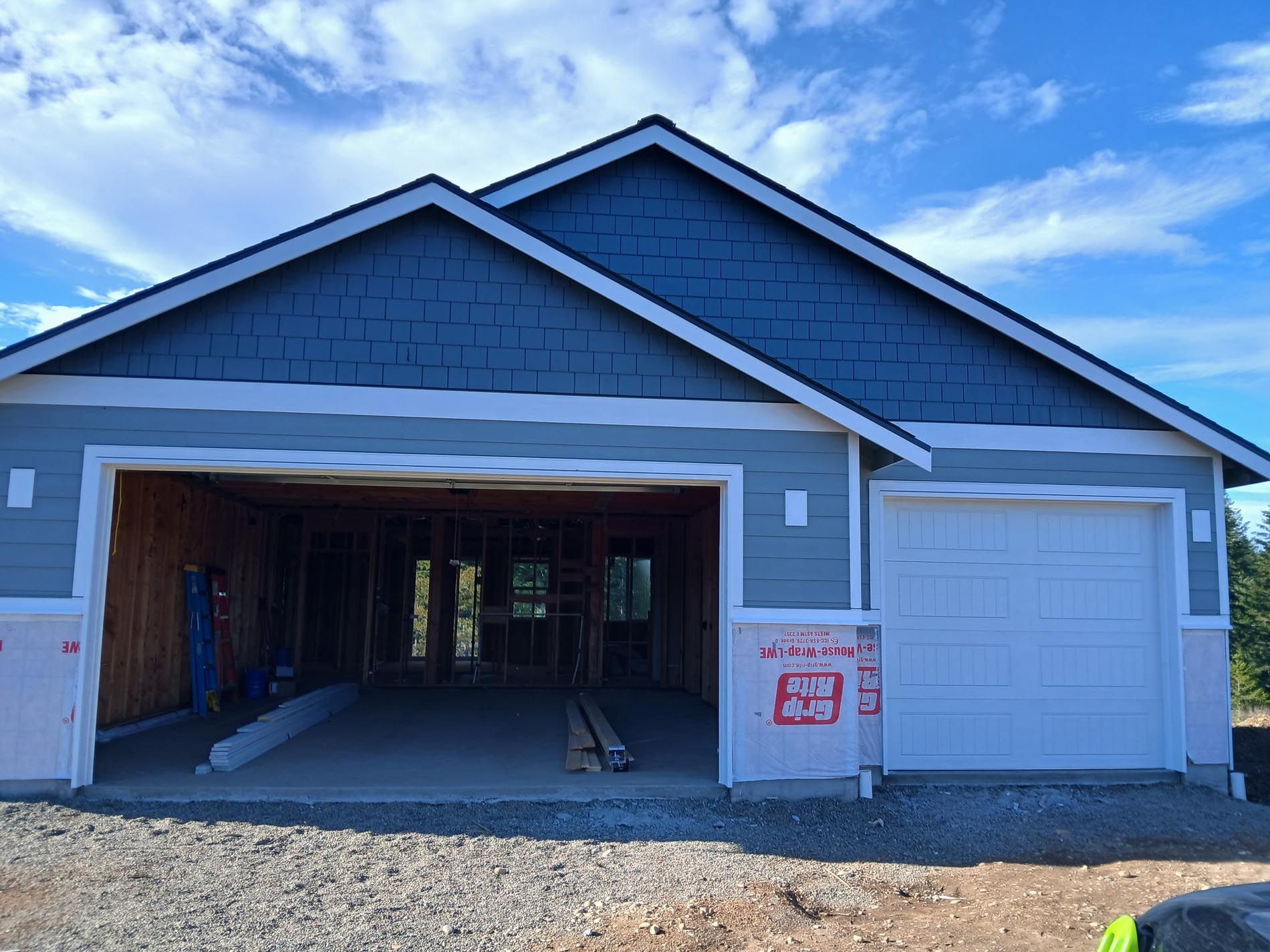 A house that is being built with the garage door open