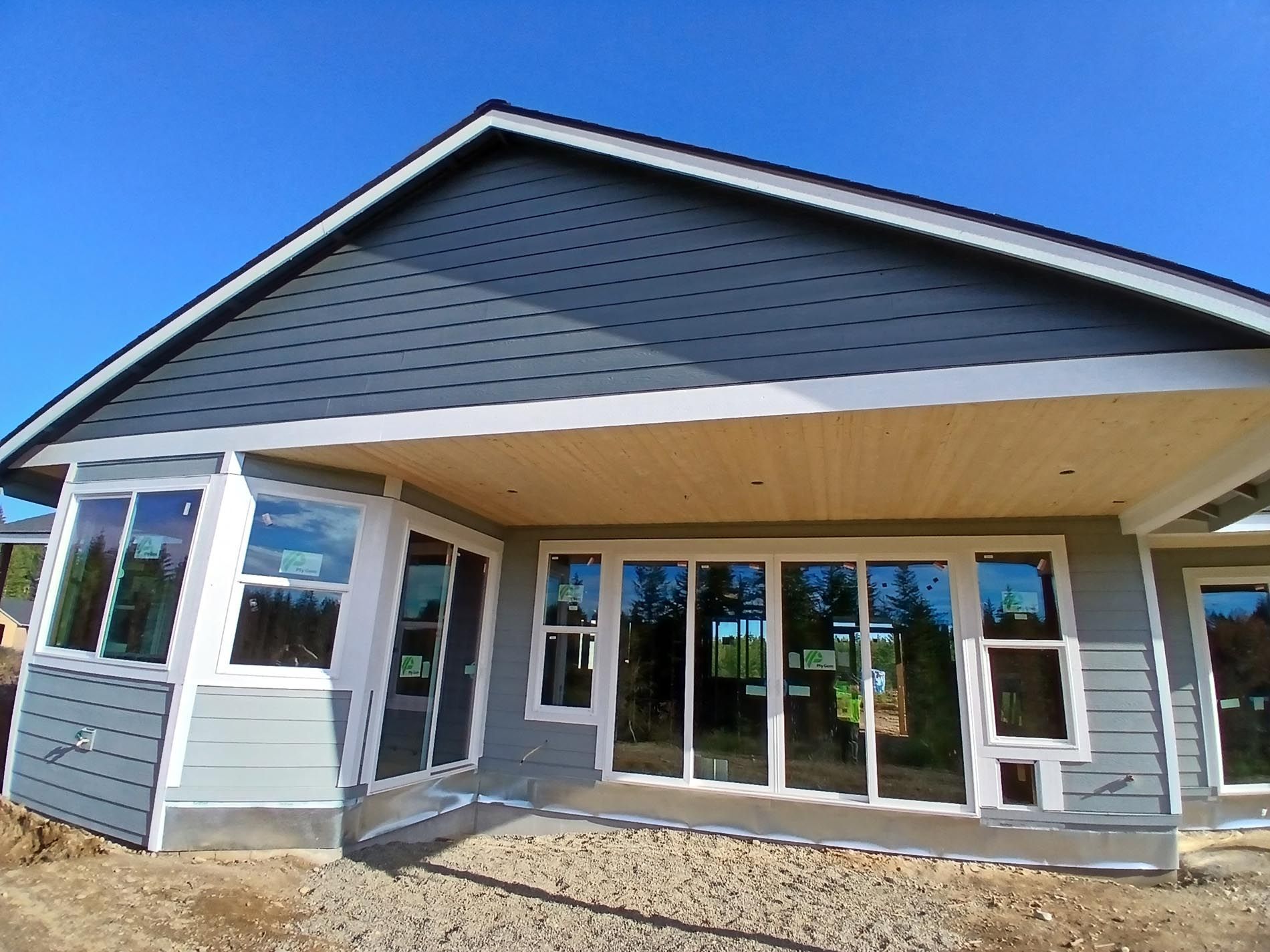 A house with a lot of windows and a blue sky in the background