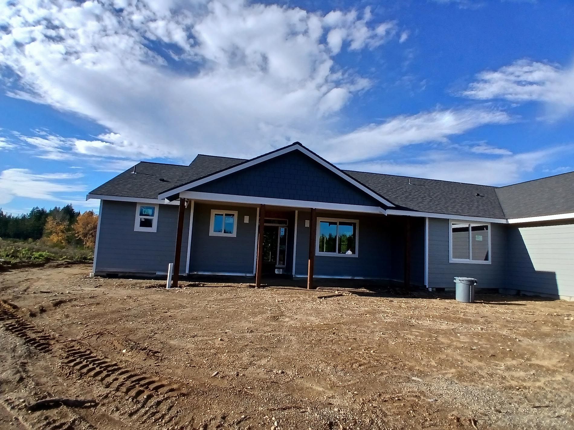 A house is being built in the middle of a dirt field.