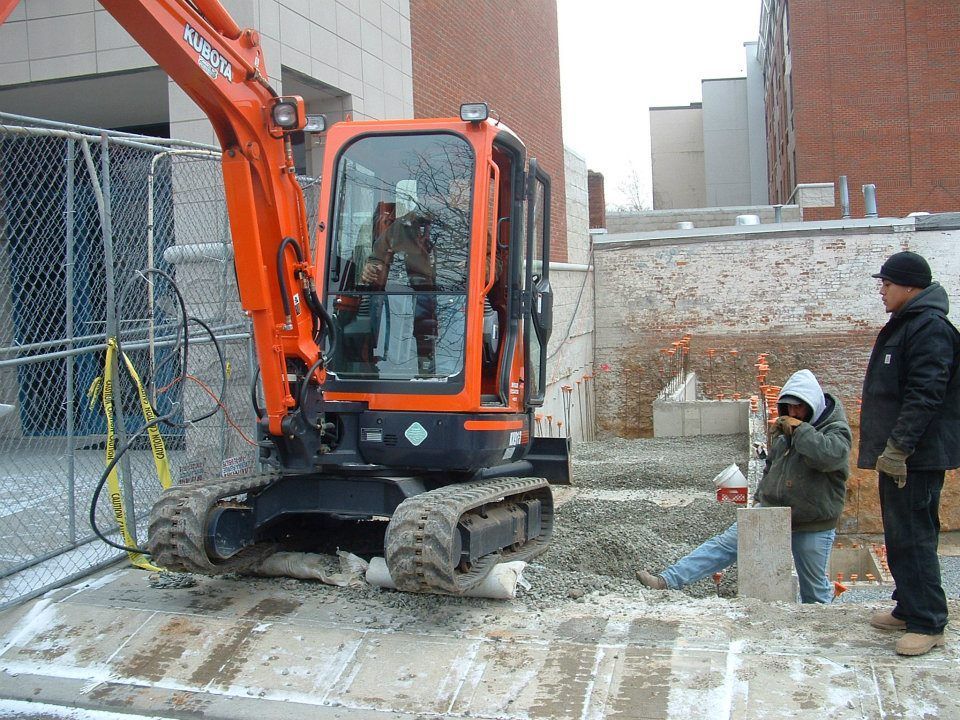 Men Standing Next To A Small Excavator | Bloomingdale, NJ | Jim Vollaro Excavating
