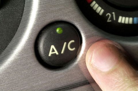 a person's finger next to AC button