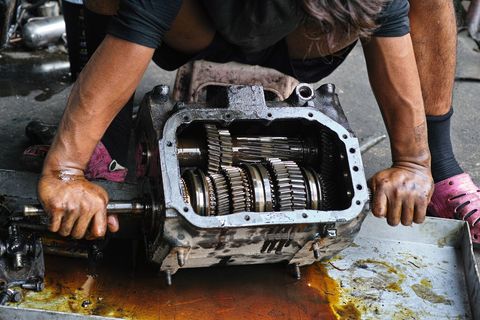 a mechanic repairing an engine part