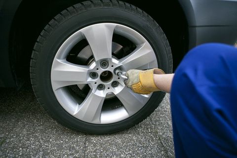 a mechanic fitting a new tyre