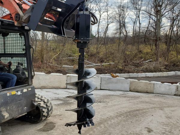A close up of a spiral drill bit on a white background.