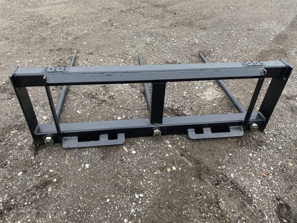 A pair of hay bale forks on a white background.