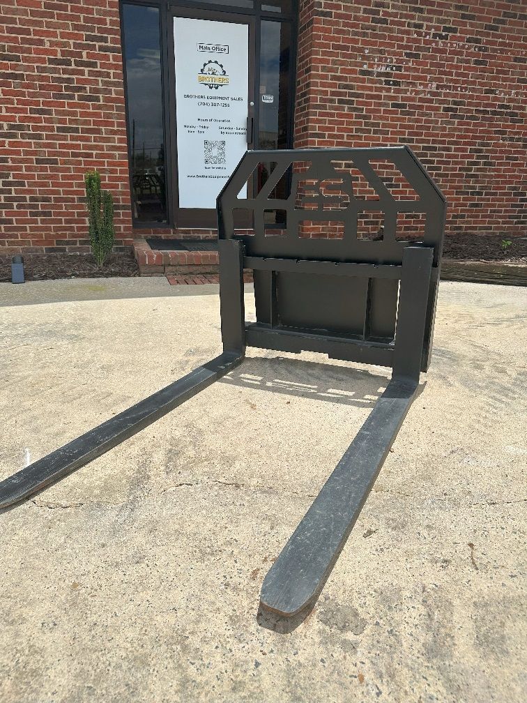 A pair of forks sitting on top of a concrete surface.