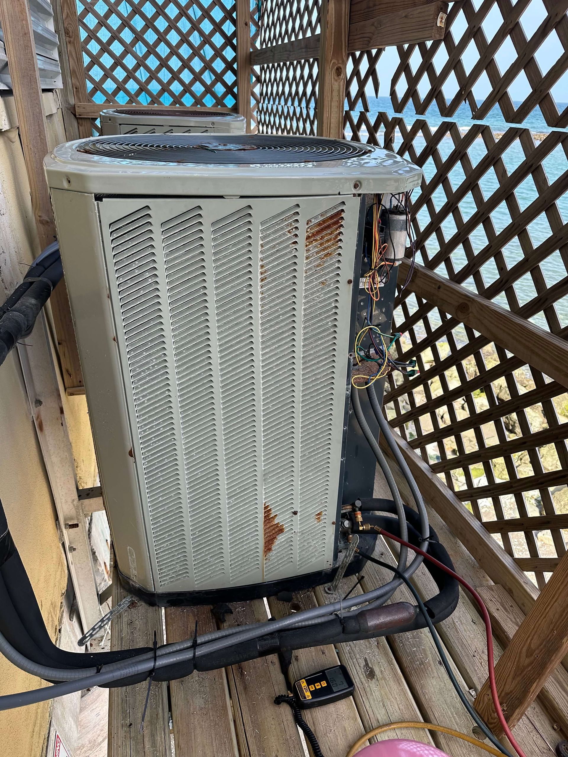 An air conditioner is sitting on top of a wooden table.