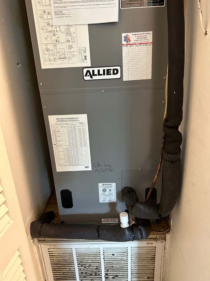 An allied air conditioner is sitting in a corner of a room.