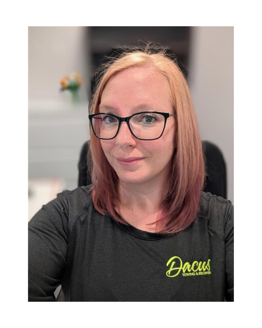 Woman with blonde and pink hair wearing glasses and a black shirt.