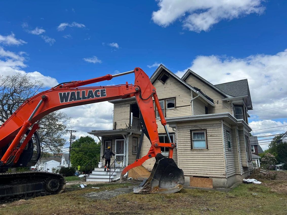 A wallace excavator is demolishing a house.