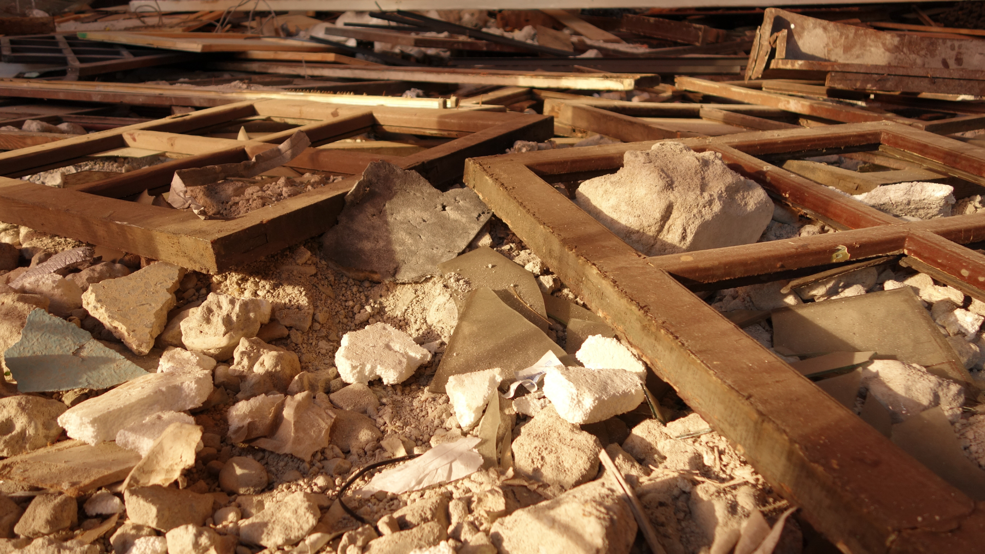 A pile of rocks and wood is laying on the ground.