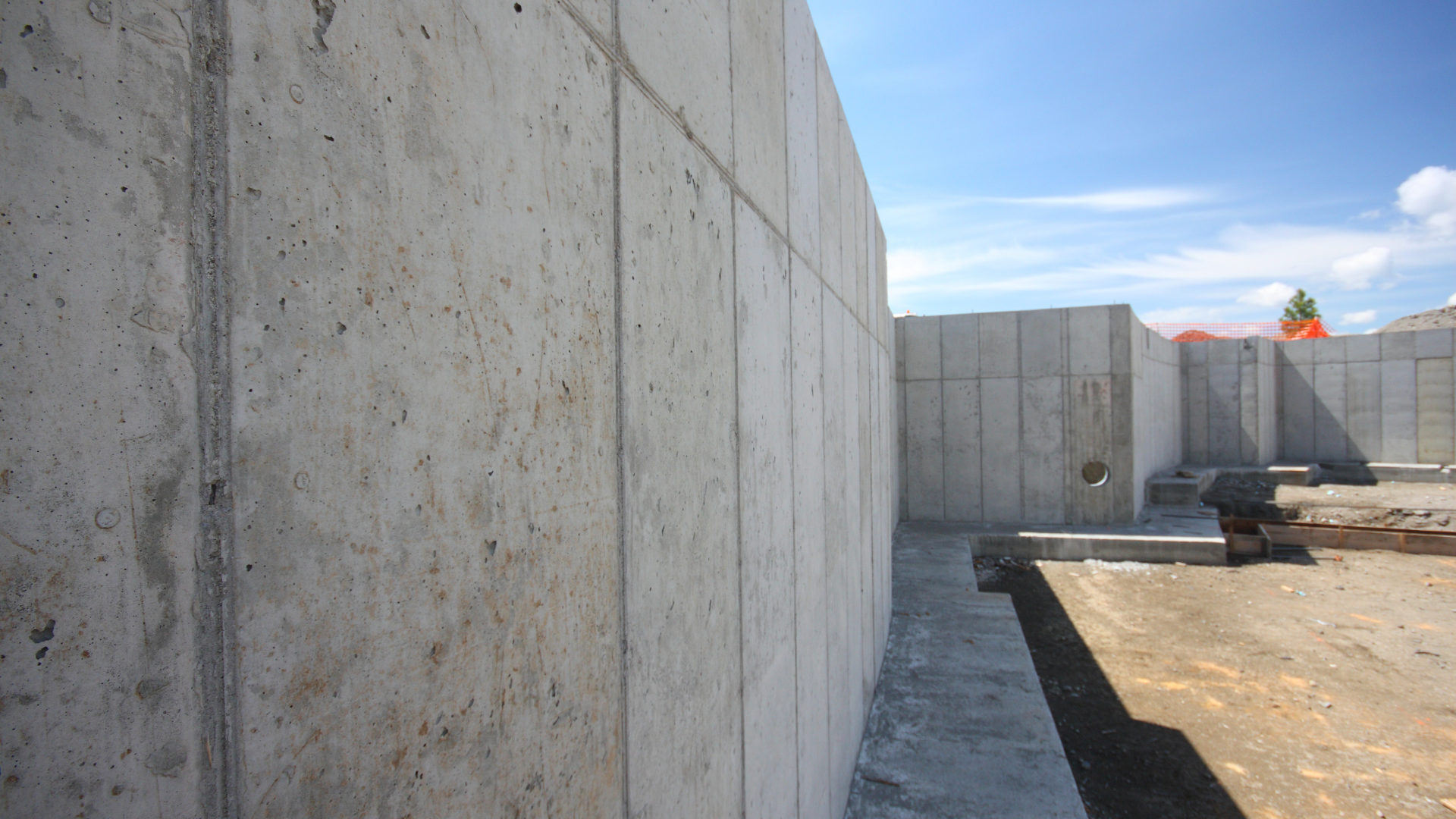 A concrete wall with a blue sky in the background
