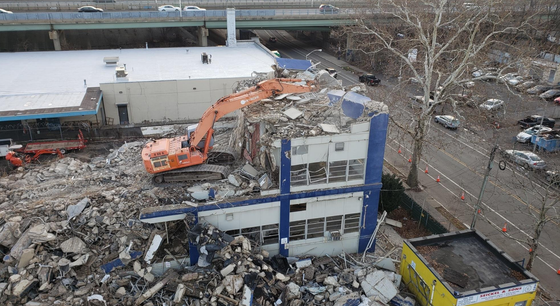 An aerial view of a building being demolished.